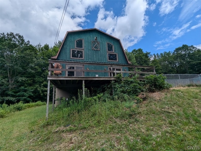 rear view of house featuring a lawn