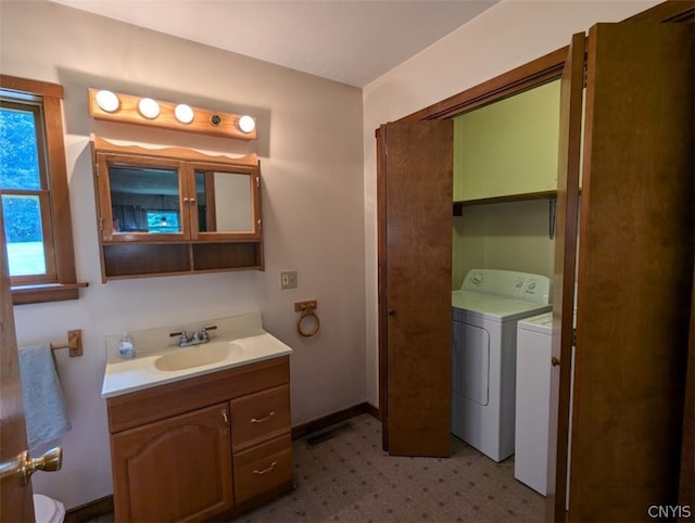 bathroom with vanity and washing machine and dryer