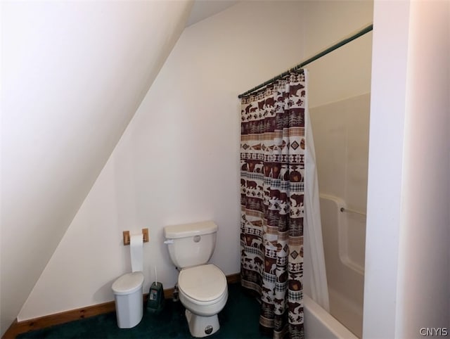 bathroom featuring toilet, shower / bathtub combination with curtain, and lofted ceiling