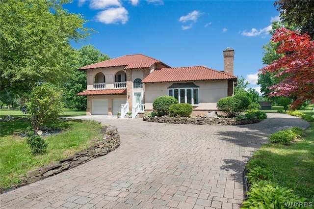 mediterranean / spanish house featuring a garage