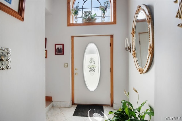 foyer entrance with light tile patterned floors