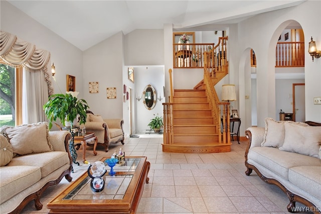 tiled living room featuring high vaulted ceiling