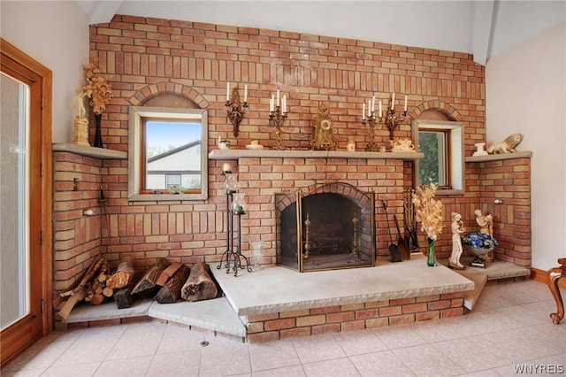 interior space featuring lofted ceiling, tile patterned floors, and a fireplace