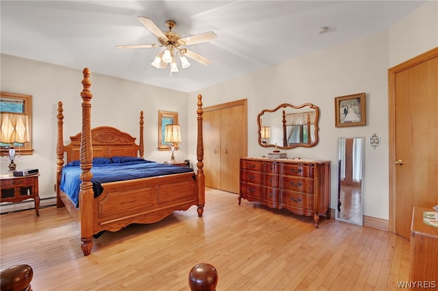 bedroom featuring baseboard heating, light wood-type flooring, and ceiling fan