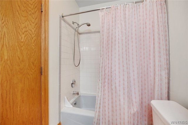 bathroom with toilet and shower / bath combo with shower curtain