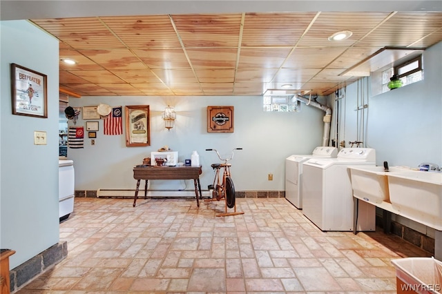 laundry area featuring washer and dryer, a baseboard radiator, and sink