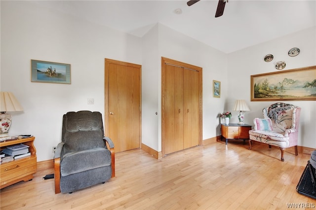 living area with ceiling fan and hardwood / wood-style flooring