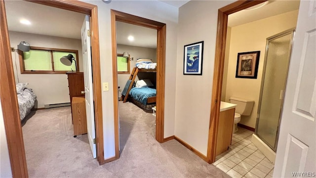 hall featuring light colored carpet and a baseboard heating unit