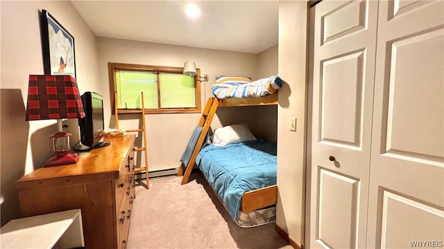 bedroom featuring baseboard heating and light carpet