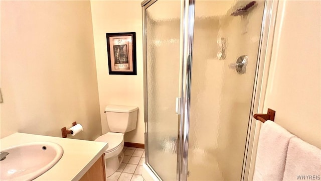 bathroom with toilet, vanity, tile patterned floors, and an enclosed shower