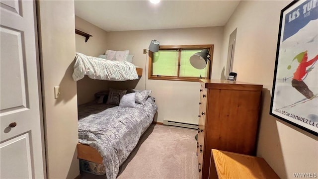 bedroom with baseboard heating and light carpet