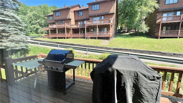 wooden terrace with a yard and grilling area