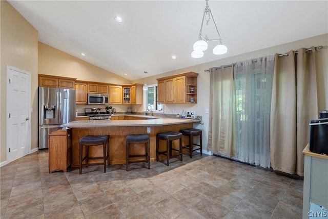 kitchen featuring stainless steel appliances, vaulted ceiling, a sink, a peninsula, and glass insert cabinets