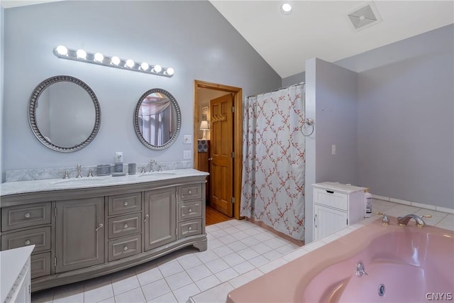 full bathroom featuring tile patterned flooring, double vanity, vaulted ceiling, a jetted tub, and a sink