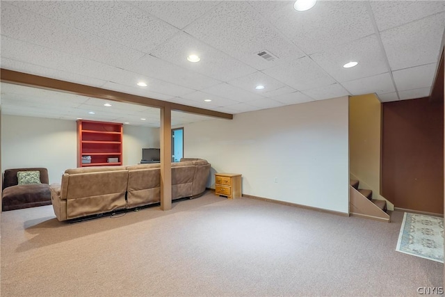 living room with a paneled ceiling and carpet floors