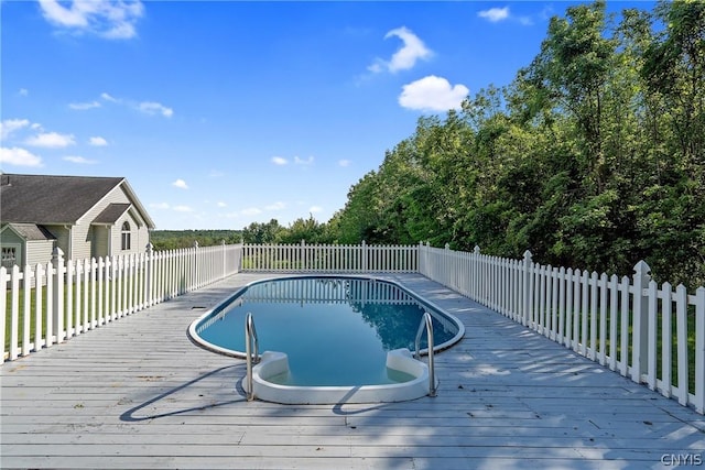 view of pool featuring a fenced in pool, fence, and a deck