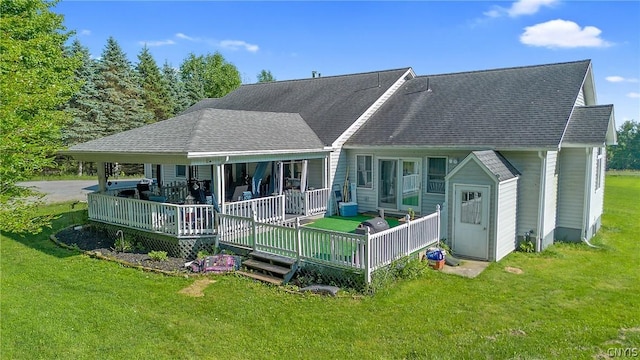 back of property featuring a lawn and a shingled roof