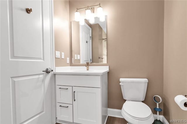 bathroom featuring toilet and vanity