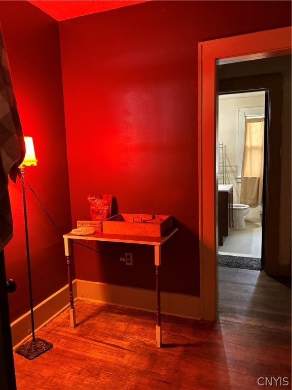 bathroom with toilet and hardwood / wood-style flooring