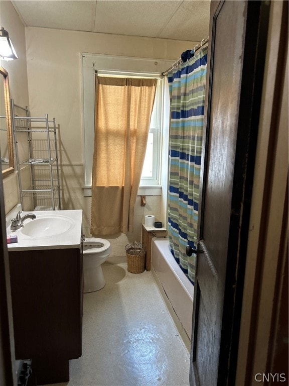 full bathroom featuring shower / bath combination with curtain, vanity, toilet, and concrete floors