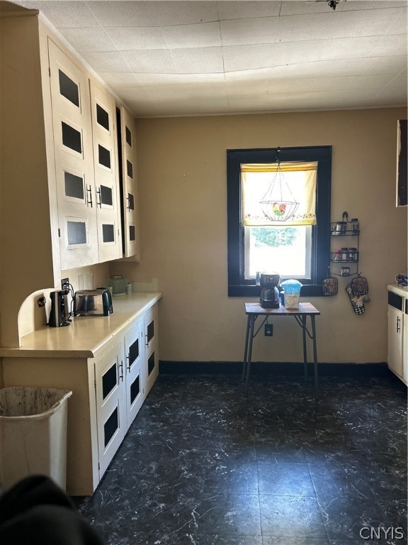 kitchen featuring white cabinetry and decorative light fixtures