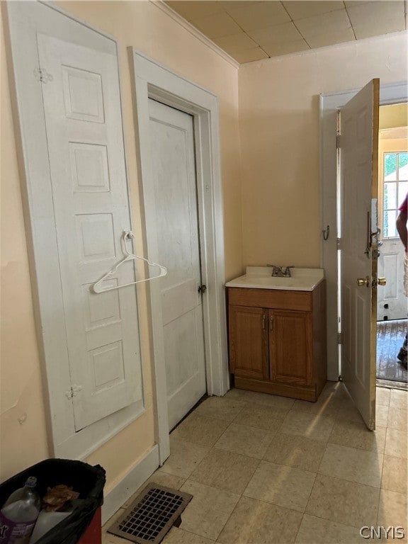 bathroom featuring ornamental molding and vanity