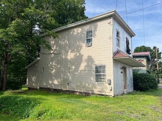 view of side of property with a yard