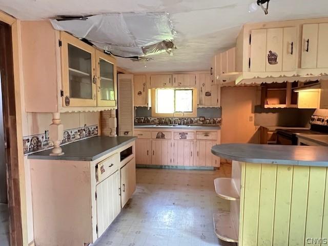 kitchen featuring stainless steel electric stove and sink