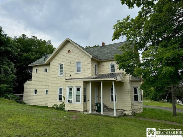 51 Fairmount Ave, Jamestown, NY 14701 - back of house featuring a standing seam roof, a yard, a chimney, and metal roof