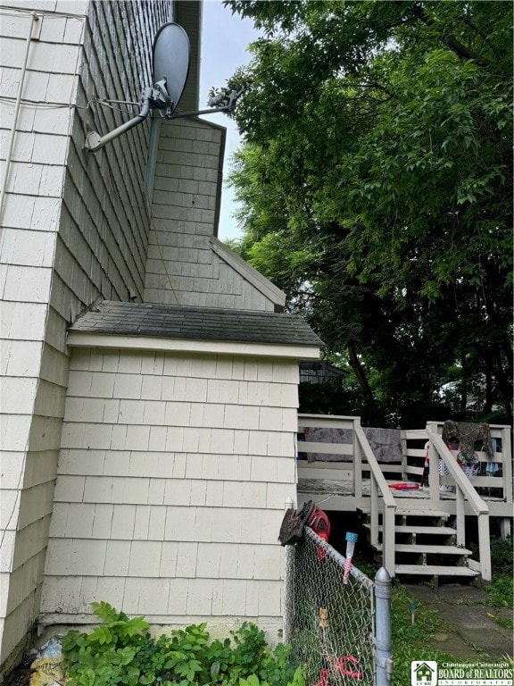 view of side of property with a wooden deck