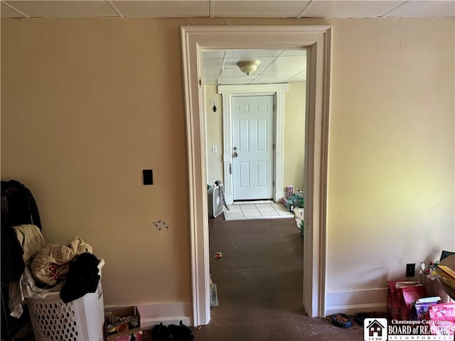 corridor with carpet and a paneled ceiling