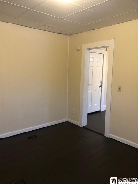 unfurnished room featuring dark hardwood / wood-style flooring