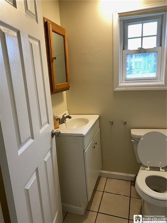 51 Fairmount Ave, Jamestown, NY 14701 - bathroom with toilet, vanity, tile patterned flooring, and baseboards
