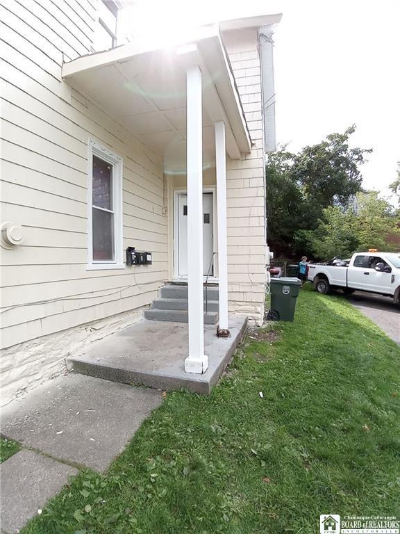 51 Fairmount Ave, Jamestown, NY 14701 - doorway to property with a lawn