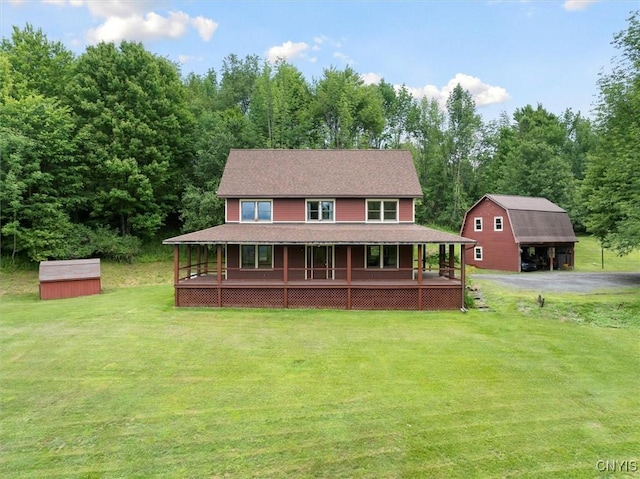 farmhouse with a shed, a front yard, and a porch