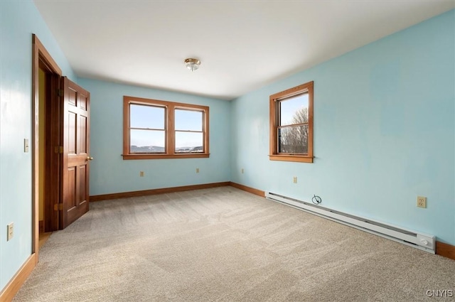 unfurnished bedroom featuring light carpet and baseboard heating