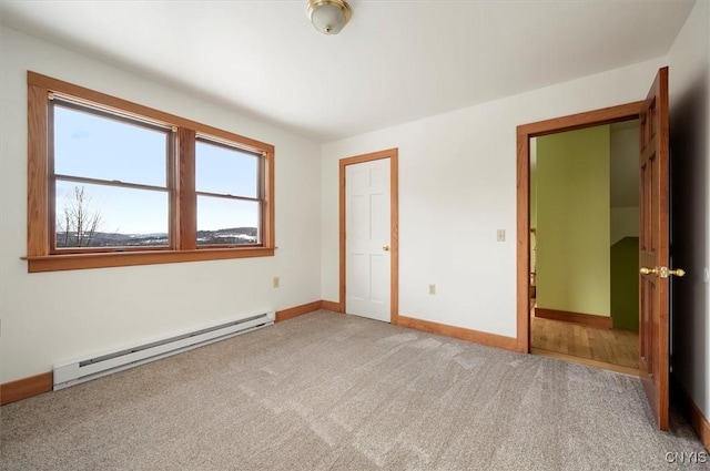 unfurnished bedroom with carpet floors and baseboard heating