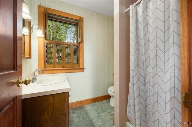 bathroom featuring walk in shower, vanity, and toilet