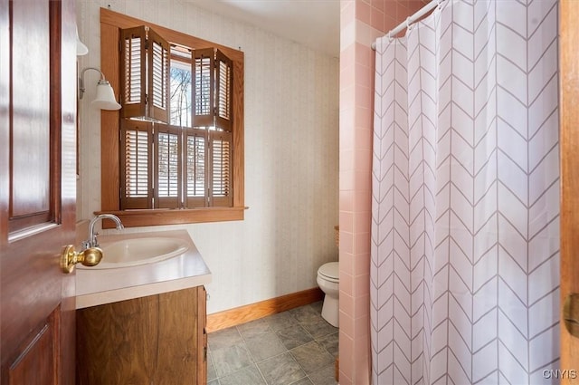 bathroom with vanity, toilet, and walk in shower