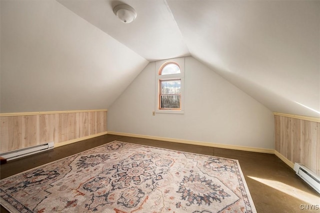 bonus room featuring vaulted ceiling, wood walls, and baseboard heating