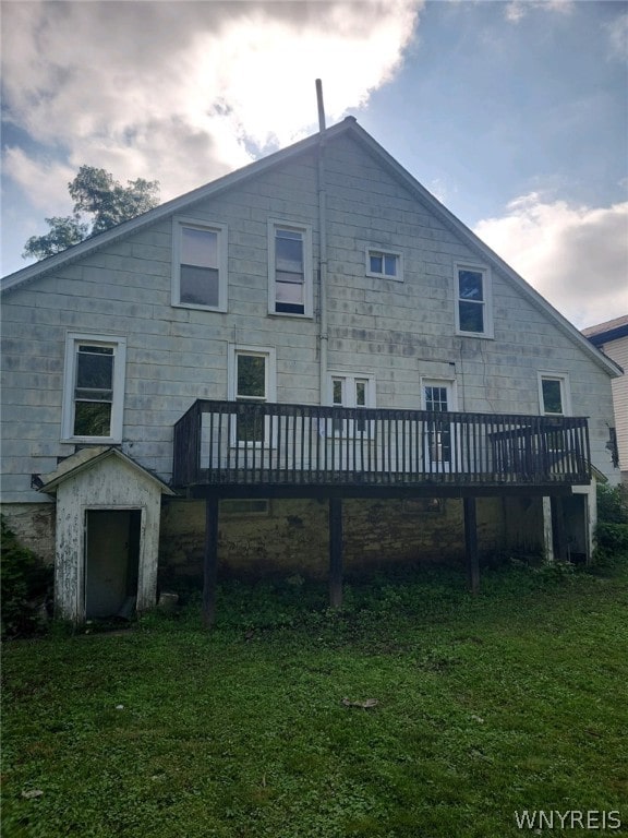 back of house with a yard and a deck