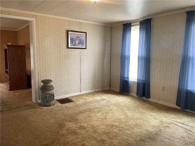 spare room featuring ornamental molding, carpet, and a healthy amount of sunlight