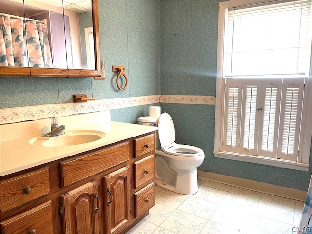 bathroom with tile patterned floors, vanity, backsplash, and toilet