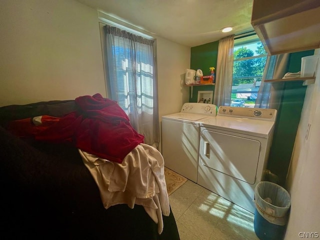 washroom featuring light floors and washing machine and clothes dryer