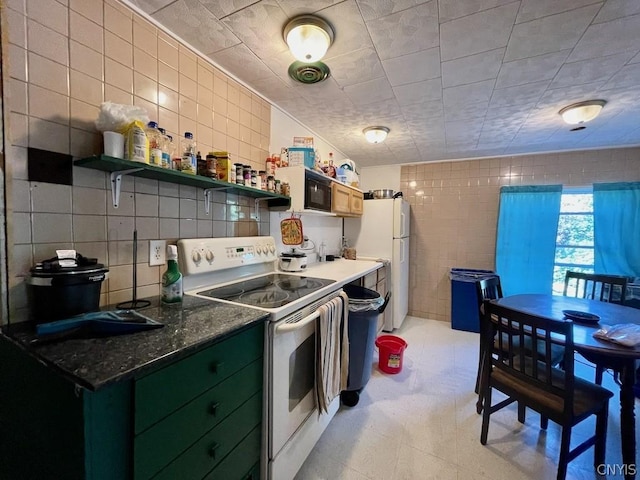 kitchen featuring open shelves, white appliances, and tile walls