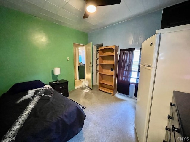 bedroom featuring freestanding refrigerator and ceiling fan