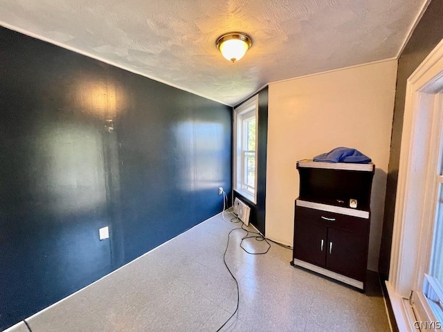 interior space featuring light floors and a textured ceiling