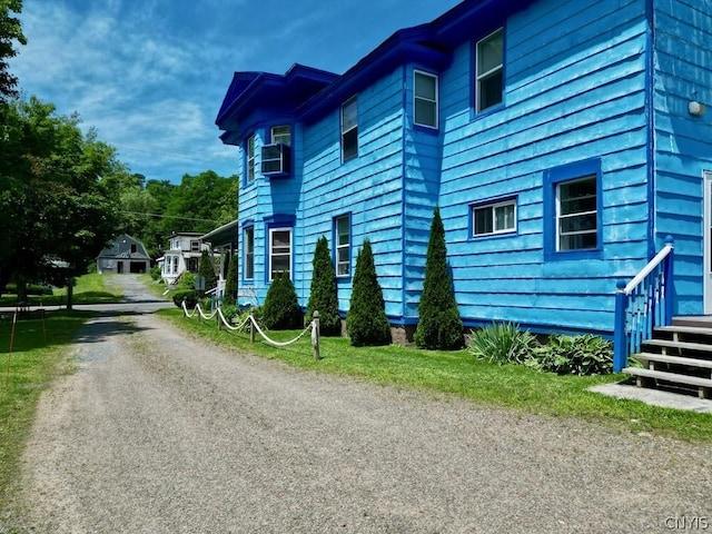 view of side of property with driveway