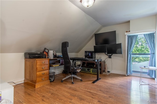 home office with wood-type flooring and vaulted ceiling