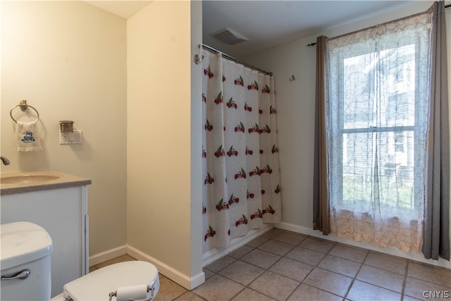 bathroom with vanity, toilet, and tile patterned floors